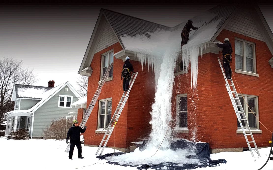 Ice dam buildup along the edge of a snow-covered roof